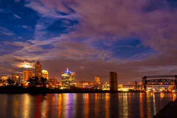 Moonrise over downtown Cleveland Ohio with city lights reflected in the Cuyahoga River