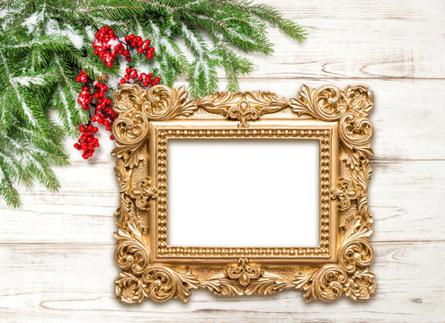Christmas decoration with golden picture frame on wooden backgro