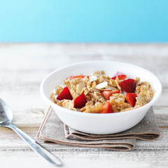 bowl of cereal with strawberries and almonds