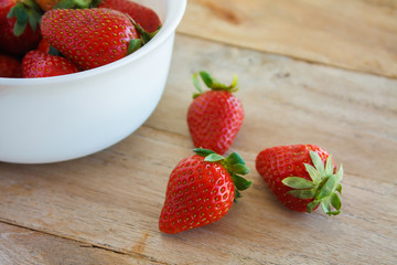 Ripe red strawberries on wooden table