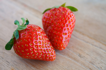 Ripe red strawberries on wooden table