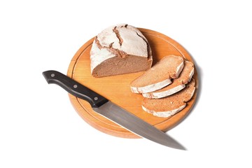 sliced rustic bread with knife on round breadboard