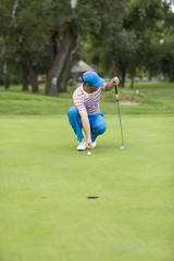 Fototapeta premium Young man playing golf