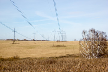 High voltage post. High-voltage tower sky background. power lines in field.