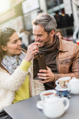 Trendy couple sitting at a terrace in the city center. 
