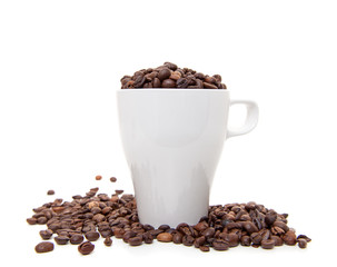Cup full of coffee beans. All on white background