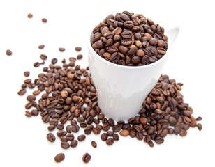 Cup full of coffee beans. All on white background
