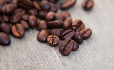 Roasted coffee beans on wooden background