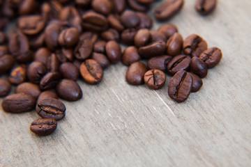 Roasted coffee beans on wooden background