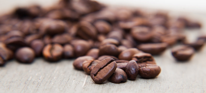 Roasted coffee beans on wooden background