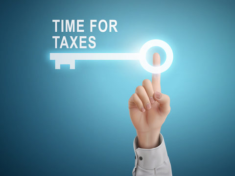 male hand pressing time for taxes key button