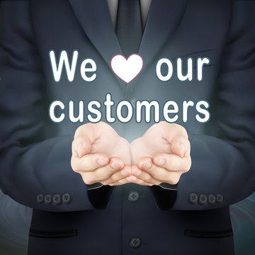 businessman holding we love our customers words