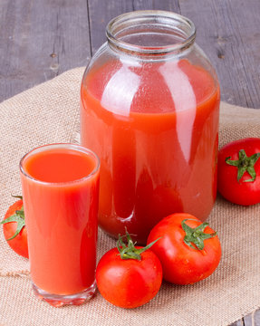 Tomato juice in glass and two-liter jar