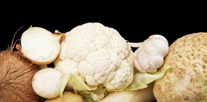Collection of white vegetables and fruits on black