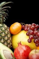 Cropped vertical view of many colorful fruits on black with reflection