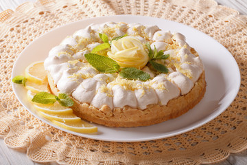A delicious lemon meringue pie on a plate. horizontal
