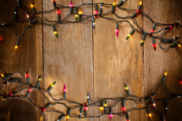 Top view, Christmas and New Year lights on old wood background - 93441480