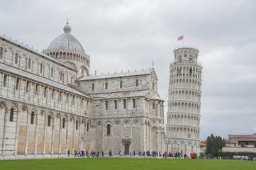 Tourist visiting the leaning tower of Pisa , Italy.
