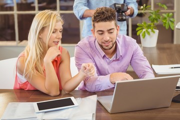 Fototapeta premium Business people discussing something using laptop