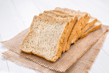 Sliced bread on white wooden table
