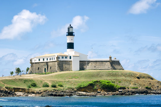 Portrait of the Farol da Barra lighthouse under clear blue sky in Salvador, Bahia, Brazil 
