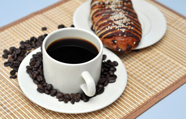 hot coffee with red bean bread on bamboo mat