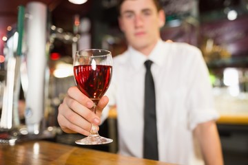 Male bartender serving alcohol