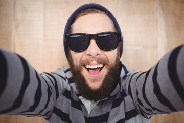 Fototapeta premium Portrait of happy hipster wearing sunglasses