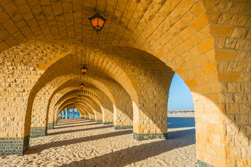 Fototapeta na wymiar The arched stone colonnade with lanterns