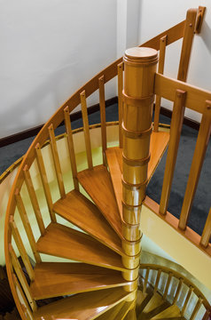 Spiral wooden staircase with varnished balusters