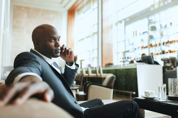 Fototapeta na wymiar African business man waiting in a hotel lobby