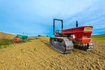 Fototapeta premium Red tractor on caterpillars on the autumn fields