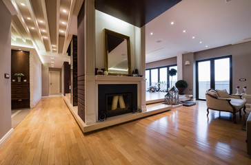Luxury apartment interior with fireplace filed with candles