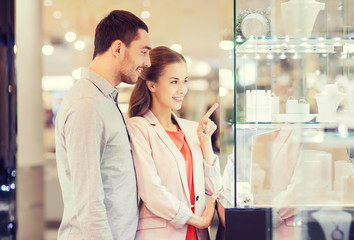couple looking to shopping window at jewelry store