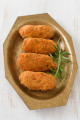 fish croquettes on dish on white background