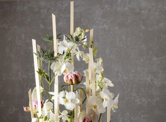 Floral arrangement with orchids and peonies