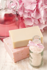 Bottle of sea salt and two bars of handmade soap.