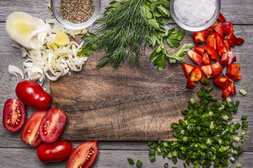Autumn vegetables and herbs on a cutting board with spices and salt on wooden background close up top view space for text