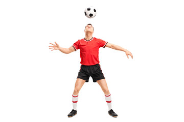 Football player juggling a ball on his head