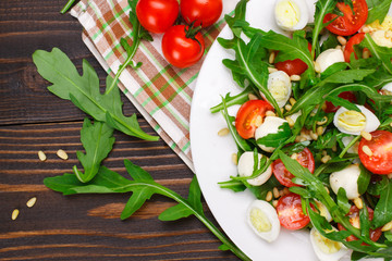 Salad with arugula on a wooden background