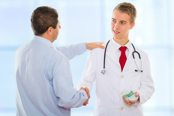 Man shaking a doctor's hand after successfully bribing him