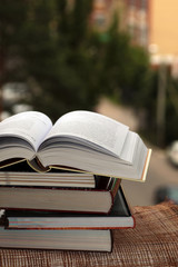 stack of books on city background