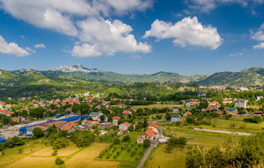 Fototapeta na wymiar Montenegro rural meadow and village houses view. Montenegro.