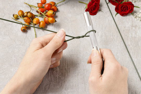 Steps of making decorative ball with rose hip, hawthorn and rowa