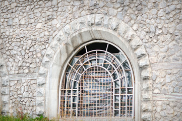broken stone barred window in the chapel
