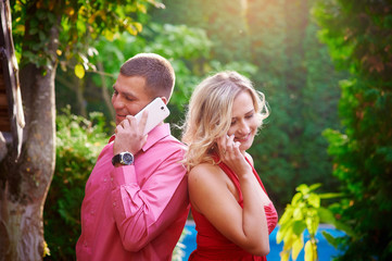 man and woman in red dress talking on the phone with each other