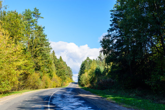 Suburban shosse, old road on sunny autumn day.