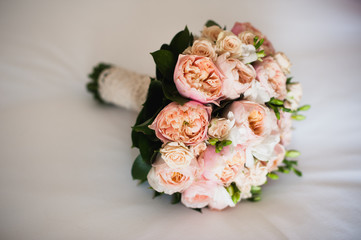 wedding bouquet on  white silken sheet