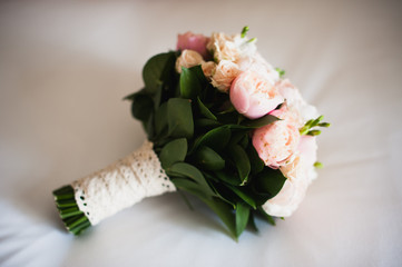 wedding bouquet on  white silken sheet