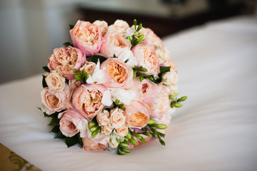 Wedding bouquet for bride on bed